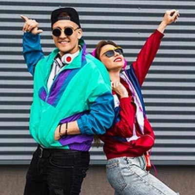 Guy and girl wearing 1980s fashion clothes